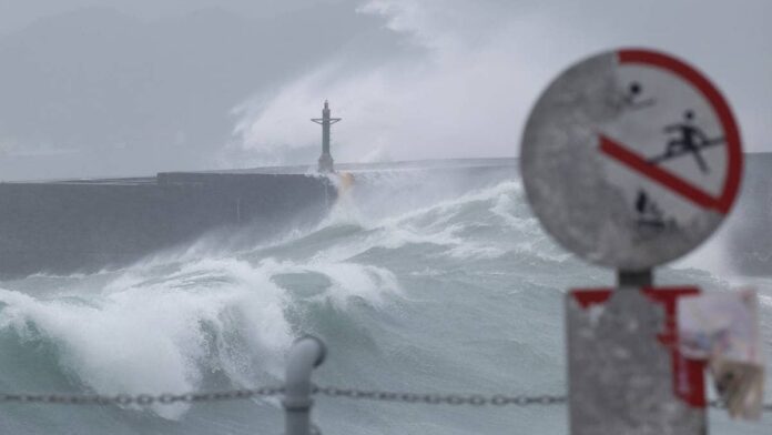 FILE PHOTO: Waves break against the protecting walls as Typhoon Gaemi approaches in Keelung